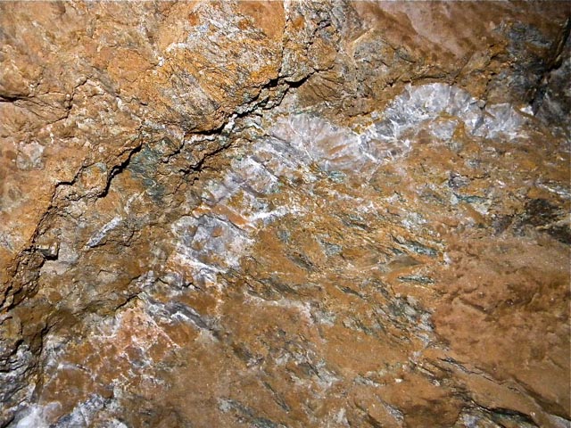 A gold-bearing rock face underground